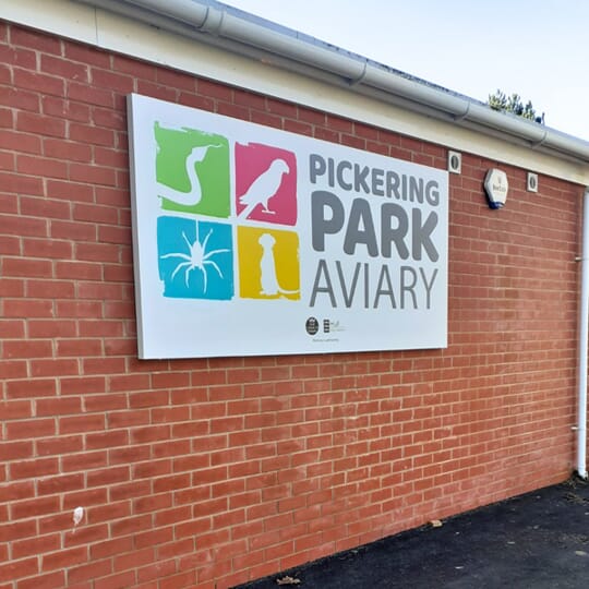 An image of the outdoor sign for pickering park aviary in hull.